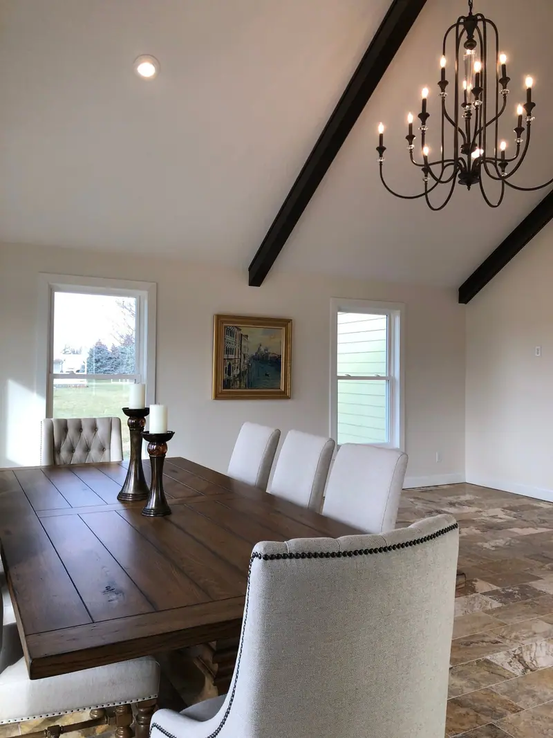 Dining room with vaulted ceiling, beams and chandelier
