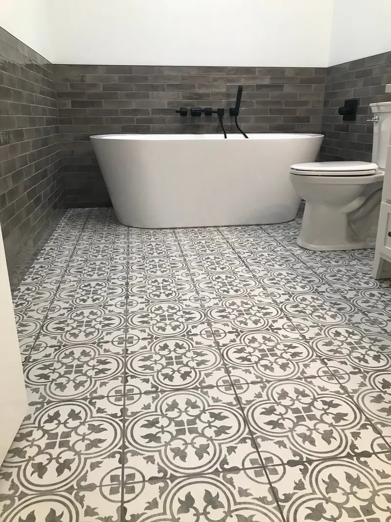 Bathroom with freestanding tub and patterned porcelain tile floor