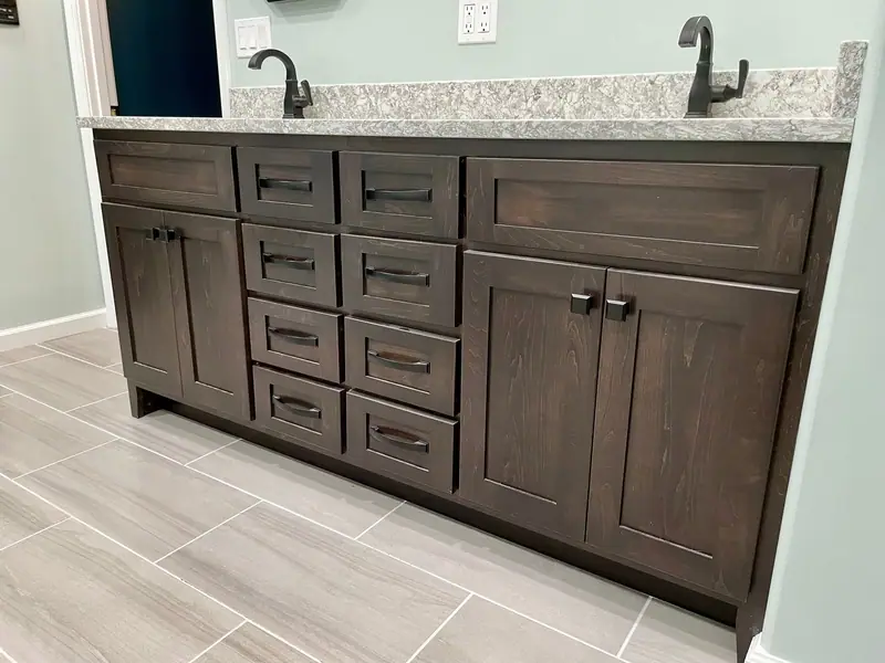 Dark wood vanity with drawer stack and quartz top