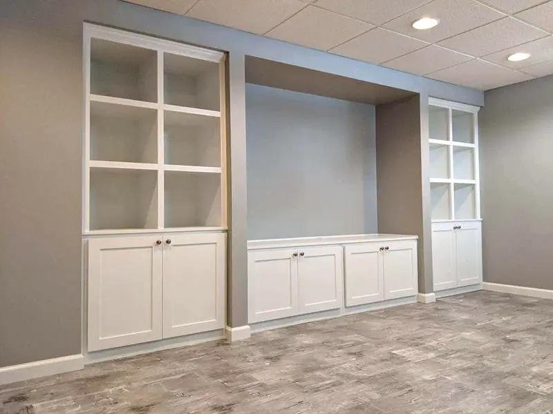 White built-in cabinets and shelving along a wall