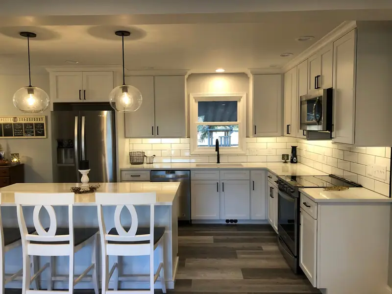 Kitchen island seating with white counter stools and pendant lights
