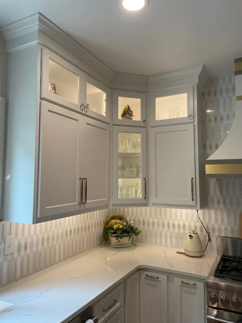 Corner cabinetry with lighted glass doors